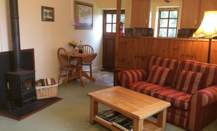 Aberyscir Coach House living room with cosy log burner and excellent WiFi